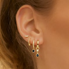 Add a touch of sparkle to your golden stack with our Rhodes Earrings. Cool and on-trend, the blue-coloured stone hangs from a perfectly adorned hoop to make a classic everyday earring that will glam up your stack!18k Gold plated (1 micron plating)Sterling Silver BaseBlue Zircon StoneE-coating for a premium finishLead & Nickel Free CARE GUIDECARING FOR YOUR AOE JEWELSAt Arms Of Eve, we take great pride in the quality of all our jewels. All of our pieces are suitable for daily wear. Our jewels are Dainty Earrings Dangle, Gold Jrwelry With Navy Dress, Everyday Ear Rings, Aimple Earrings, Dath Piercing Earrings, Casual Jewelry Earrings, Earrings Cool, Double Earrings, Fabulous Style