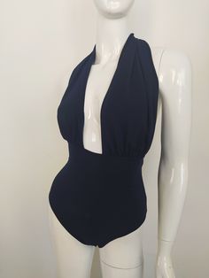 "FREE SHIPPING TO USA FOR ALL ORDERS OVER 35$! Choose right size by following our size chart below, thank you! We use FEDEX PRIORITY shipping service to the United States to guarantee the fastest delivery in 3-4 days. Flattering one piece swimsuit in dark blue fabric with open back and high cut. It has a deep neckline secured at the back of the neck with a halter tie. Stretchy and body fitting material. COLOR: DARK BLUE MEASUREMENTS: X-Small - Bust - 32\" - 34\" (82-86 CM) - Hips - 35\" - 36\" ( Fitted Backless Bodysuit For Pool, Summer Backless Bodysuit With Lined Body, Fitted Backless Bodysuit For Beachwear, Fitted Backless Beachwear Bodysuit, Elegant Halter Neck Bodysuit For The Beach, Fitted Halter Neck Bodysuit For Beachwear, Stretch Lined Backless Swimwear, Fitted Halter Neck Bodysuit For Pool, Chic Backless Bodysuit For Beach Party