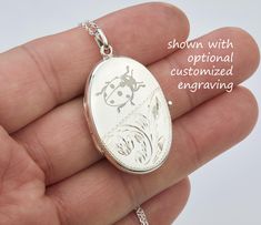 Carrying the pictures of your loved ones close to your heart all the time, this large personalized locket necklace features: 1. a large (33 x 23 mm without bale) oval solid sterling silver locket (8.5 grams)  Its front's lower portion is etched with a floral pattern. The upper portion and the back (plain) can be engraved (use pulldown menu to select) with monograms, text, or graphics (limited to black/white, line drawing type). handwriting or fingerprint *  * fingerprint engraving will incur $10 surcharge for extra long engraving time.   2. the locket can two pictures inside. Photo insertion service is available for $14 each photo (please attach your locket photos to a conversation) 2. a sterling silver chain with a lobster clasp.      You can upgrade your chain using this listing: Silver Locket Necklace For Memorial On Mother's Day, Silver Locket Necklace For Mother's Day Memorial, Silver Oval Pendant For Personalized Gift, Silver Oval Pendant Jewelry For Personalized Gift, Engraved Sterling Silver Locket Necklace For Mother's Day, Engraved Oval Link Locket Necklace For Wedding, Mother's Day Sterling Silver Locket Necklace Keepsake, Personalized Silver Locket Necklace For Anniversary, Silver Locket Necklace With Engraving Option As Gift