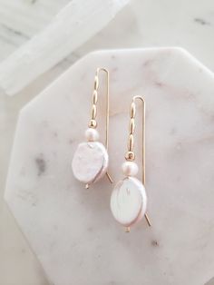 These earrings are unique yet perfectly on trend and timeless. Perfect for dressing up a casual look or for a bride on your wedding day! Handmade from top quality materials. Genuine lustrous freshwater coin pearls are threaded with 14k gold filled beads on 14k gold filled wire. Gold fill does not wear off like gold plated. Water safe! Hypoallergenic, lead and nickel free. Comfortable and lightweight! Come packaged in a gift box. **What is 14k Gold-fill?** Gold fill does not tarnish or wear off a Feminine Pearl Earrings With Pearl Chain, 14k Gold Filled Pearl Drop Earrings For Anniversary, Pearl White Pearl Drop Linear Earrings, Pearl White Linear Pearl Drop Earrings, Delicate Pearl Drop Linear Earrings, Feminine Pearl White Earrings With Pearl Drop, Delicate Pearl White Pearl Drop Earrings, Feminine Pearl White Drop Bridal Earrings, Feminine Pearl Earrings