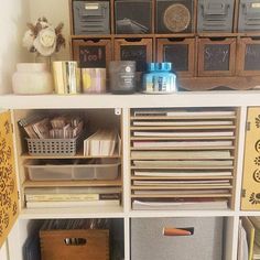 the shelves are filled with many different types of boxes and file folders on them