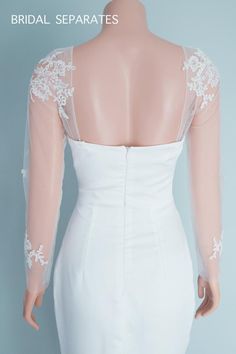 the back of a brides dress with white lace on it, and an open neckline