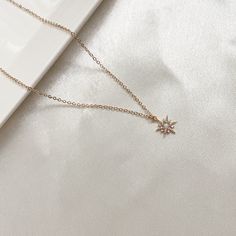 This is a dainty necklace with a sparkly opal star pendant. Perfect for everyday wear. Can be paired with out Scarlett cuff earrings. Opal is the October birthstone and is considered a stone representing hope, innocence and purity. It has strong connotations of happiness, faithfulness, loyalty and confidence. Necklace Metal: 14K Gold filled Necklace Size: 16 in + 2 in extender Pendant Metal : 14K Polished Gold PlatedPendant Size: 11 mm Pendant Stone: Opal and cubic zirconia Model is layering thi Elegant Star-shaped 14k Gold Filled Jewelry, Elegant 14k Gold Filled Star Jewelry, Dainty Cubic Zirconia Jewelry With Star Charm, Dainty Star-shaped Rose Gold Jewelry, Dainty Rose Gold Star Jewelry, Dainty Star-shaped Cubic Zirconia Necklace, Dainty Sparkling Star-shaped Jewelry, Dainty Sparkling Star Jewelry, Dainty Cubic Zirconia Star Necklace