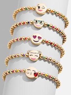 The Kids' Emoji Pisa Bracelet Set comes with five unique gold beaded bracelets. Each bracelet is complete with a bead in the center in a range of fun emoji motifs: the winky face, the smarty pants face, the crush face, the angel face, and the kissy face. Gift as a set to your little one, or split them apart to gift to them and all of their friends. Please note: intended for children 3+, packaging may vary. Winky Face, Kissy Face, Gold Bead Bracelets, Angel Face, Beaded Stretch Bracelet, Pisa, Gold Beads, Stretch Bracelets, Bracelet Designs