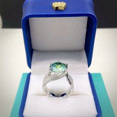 an engagement ring in a blue box