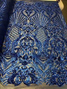 blue sequins are covering the surface of a piece of cloth