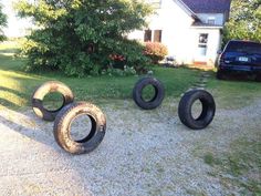 four tires are sitting on the ground in front of a house with an emoticive message