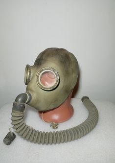 an old gas mask with a hose attached to it