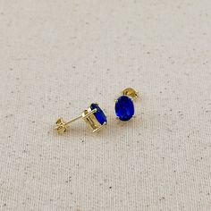 These elegant stud earrings feature stunning oval-cut cubic zirconia stones in a rich sapphire blue hue. The classic oval shape of the stones adds a touch of sophistication, while the brilliant blue color catches the eye and complements a variety of skin tones. These versatile studs are perfect for both everyday wear and special occasions, adding a pop of color and sparkle to any outfit. The secure post backing ensures comfort and stability throughout the day. Whether worn alone for a subtle sta Hand Chain Bracelet, Sapphire Earrings Studs, 18k Gold Chain, Glamorous Look, Cz Stud Earrings, Hand Chain, Sapphire Earrings, Emerald Jewelry, Anklet Jewelry