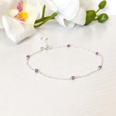 26.00 GBP This beautifully simple bracelet is lovingly handmade with a six tiny Amethyst gemstones and a choice of 14k Gold Filled, 14k Rose Gold Filled or Sterling Silver ​Chain. M A T E R I A L S: • Amethyst • 14k Gold Filled, 14k Rose Gold Filled or Sterling Silver Chain S I Z E: • Gemstones - Approximately 2-3mm • Chain Thickness - Approximately 1.1mm All of our jewellery is carefully handmade using good quality materials and handpicked gemstones, with the aim to produce quality pieces… Dainty Sterling Silver Bracelets With Natural Stones, Dainty Sterling Silver Crystal Gemstone Bracelet, Dainty Amethyst Bracelet Jewelry, Dainty Sterling Silver Gemstone Crystal Bracelet, Dainty Sterling Silver Bracelet For Anniversary, Delicate Amethyst Birthstone Jewelry, Dainty Sterling Silver Bracelet With Gemstone, Dainty Amethyst Bracelets For Gift, Dainty Purple Gemstone Bracelets