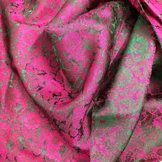 a pink and green fabric with floral designs on the top, as well as an image of