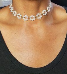 Whether you're attending a special occasion or simply want to feel fabulous, our Floral Pearl Choker is the perfect accessory to make a statement and leave a lasting impression. Embrace your inner charm and let this enchanting piece adorn your neck with sheer elegance. Chic White Choker Jewelry, Adjustable Clavicle Chain Jewelry For Evening, Glamorous Round Pearl Jewelry, White Rhinestone Clavicle Necklace For Party, White Rhinestone Clavicle Chain Necklace For Party, Chic Pearl Choker For Wedding, Glamorous Party Jewelry With Clavicle Chain, Glamorous Party Clavicle Chain Jewelry, Glamorous Party Choker Jewelry