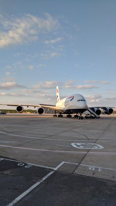 an airplane sitting on the tarmac with another plane in the back ground behind it