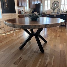 a large wooden table sitting on top of a hard wood floor