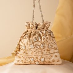 "Beautiful Wedding Indian Katdana Pearl Beaded Bridal Potli Purse Bag | Hand Embroidered Satin Cream Fabric Drawstring Pouch Purse Mobile Bag Package Contents: 1 Size: 10\" x 8\" Designed with the heart, this beautiful Potli or batawa bag are eye catchy and made of premium material. Key Features: Embroidery art work.  This potli is good match with both Indian and western outfits and are superb for wedding and festive parties. This would be best complement to your designer saree, lenhga or any other kind of dress. This is the combination of traditional and modern embroidery work. This is enough to keep your accessories and all needed essentials and it can be a best gift for any woman." Beaded Rectangular Potli Bag For Festive Occasions, Embellished Pouch Bag For Reception, Festive Beaded Rectangular Potli Bag, Festive Rectangular Beaded Potli Bag, Festive Embellished Potli Bag As Gift, Traditional Beaded Pouch Clutch, Traditional Beaded Clutch Bag, Beaded Bags For Festivals And Festive Occasions, Beaded Festive Bag For Festivals