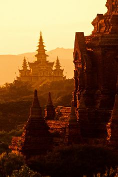 the sun is setting over an ancient temple in bagan, burma photo by jeff mc