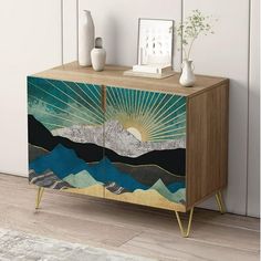 a wooden cabinet with an abstract painting on it