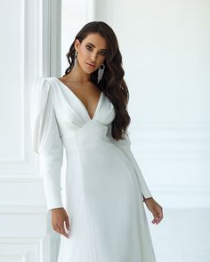 Fabric: Heavy Satin Cotton 50%, Polyester 50% V-neck dress Puffed sleeves Long sleeves Bow on back detail Zipper on back Dress lenght: 125 cm/ 49,2 inSleeve length: 68 cm/ 26,7 in Colors: White, Sky-Blue, Dusty Pink V-neck Dress With Elastic Sleeves For Brunch, Formal V-neck Mini Dress With Pleated Sleeves, Fitted V-neck Puff Sleeve Dress For Wedding, Chic V-neck Long Sleeve Dress With Gathered Sleeves, Elegant V-neck Midi Dress With Elastic Sleeves, Elegant Fitted V-neck Dress With Gathered Sleeves, Cocktail V-neck Mini Dress With Gathered Sleeves, Chic V-neck Long Sleeve Wedding Dress, Formal Dress With Structured Shoulders And Balloon Sleeves