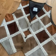 "This piece is a vintage ladies vest from the 1990s. This button up waist coat has a front that is entirely made up of patchwork multicolour genuine leather with lengths of an almost lace-y material along each seam.  -Made in India -Genuine Leather Shell -No Major Stains, Yellowing, or Flaws Tag Size: XL *refer to measurements for true fit* Pit to Pit: 22\" Length: 23\" Please also assess the photos and measurements carefully using your own personal judgement as we do not accept returns. Keep in mind that this is a piece of vintage clothing that may hold a residual scent from its past. While we wash all of the clothing we sell (except for certain items which are steam cleaned) we cannot guarantee that we have been able to remove all of the stubborn scents. Buyers should be prepared for the Retro Patchwork Vest For Fall, Brown Patchwork Vest For Fall, Ladies Vest, Patchwork Vest, Leather Waistcoat, Art Deco Print, Waist Coat, 1990s Fashion, Vintage Vest