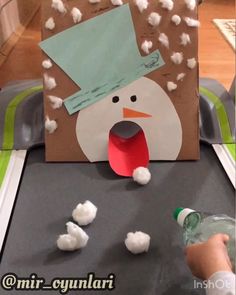 a snowman made out of paper and cotton balls