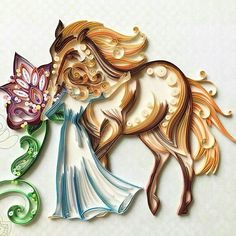 a paper cut out of a horse with flowers on it's tail and a butterfly in its mouth