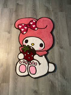 a hello kitty rug with a strawberry on it