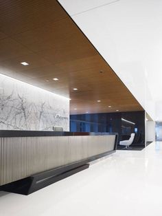 an empty lobby with marble walls and white floors