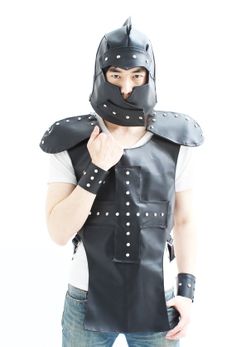 a man wearing a leather vest and mask