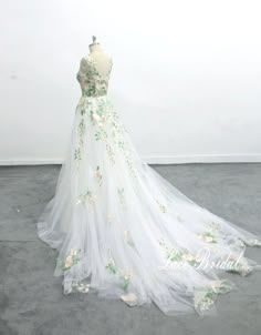 a white wedding dress with flowers on it