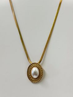 18k Vintage Gold Plating Faux Pearl Pendant Size: 1" x 1.25" Chain Length: 16" Extension Length: 2" Elegant Gold Locket Necklace, Gold Metal Pendant Locket Necklace, Elegant Gold Pendant Locket Necklace, Gold Oval Pendant Chain Necklace, Tarnish Resistant, Gold Chain Necklace With Tarnish Resistant Oval Pendant, Gold Chain Necklace With Oval Pendant, Tarnish Resistant, Classic Metal Jewelry With Pearl Pendant, Gold Oval Pendant Chain Jewelry, Gold Pendant Charm Necklace For Formal Occasions