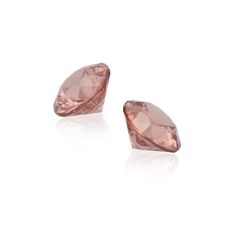 Petal-icious Pair. Zircon is a precious gem, not to be confused with cubic zirconium, which is an inexpensive diamond substitute. These perfectly matched round cuts are fantastic as the basis for a pair of earrings or cufflinks. The delicate rose-pink color is associated with romance by many metaphysical sources. The gentle pink shade is also believed to be helpful in developing self-esteem.Gemstone Details Identification: Natural Rose Zircon Carat: 6.80 Total Carats Shape: Round Color: Rose Mea Luxury Blush Gemstone Jewelry, Luxury Cubic Zirconia Gemstones With Vvs Clarity, Luxury Round Cut Cubic Zirconia Gemstone, Elegant Diamond Cut Gemstones For Formal Occasions, Elegant Diamond Cut Gemstones For Formal Events, Formal Round Diamond Earrings With Gemstones, Luxury Faceted Gemstones For Wedding, Elegant Faceted Gemstones For Formal Occasions, Formal Diamond Cut Diamond Earrings With Round Stone