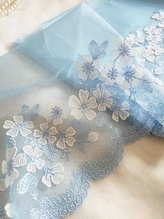 two pieces of blue fabric with white flowers on them