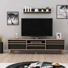 a living room scene with focus on the television and entertainment center that's surrounded by pictures