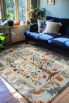 a living room with blue couches and a tree rug on the floor in front of a window