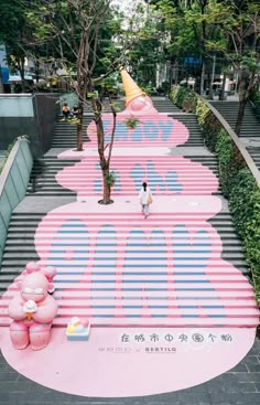 a person standing in front of a giant pink sign