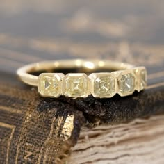 Another one from our band collection, this time using a small parcel of fancy yellow asscher cut diamonds we came across. Set in simple, handcrafted bezels to further enhance their yellow colors. Low set on the finger, offering sunshine vibes! 18kt yellow gold Size 6, and fully sizable Natural diamonds are fancy yellow in color, VS clarities Measures: 2.72mm H & 17.75mm W Yellow Rose Cut Diamond Jewelry, Yellow Gold Jewelry With Bezel-set Yellow Sapphire, Gold Octagon Jewelry With Rose Cut Diamonds, Yellow Gold Sapphire Jewelry With Bezel Setting, Yellow Sapphire Jewelry With Bezel Setting In Yellow Gold, Gold Emerald-cut Yellow Sapphire Jewelry, Gold Emerald Cut Yellow Sapphire Jewelry, Gold Jewelry With Emerald Cut Yellow Sapphire, Diamond Jewelry With Asscher Cut Bezel Setting