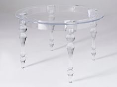 a clear glass table with wooden legs