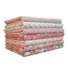 a stack of pink and white floral fabrics