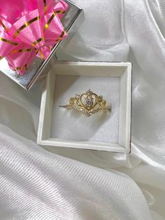 This beautiful Quinceañera crown ring is made with real 14k GOLD. Doesn't have the 15 so could be versatile. Detailed with CZ stones.  Feel free to message with any questions or concerns! Sizing is free! Message if you need a size that is not listed below. Quinceanera Jewelry Rings, Princess Style Cubic Zirconia Wedding Jewelry, Elegant Wedding Rings With Round Crown, Gold Heart Ring With Center Stone In 14k Gold, Crown Shaped Cubic Zirconia Wedding Rings, Gift Crown Design Diamond Ring, Crown Shaped Ring With Prong Setting For Promise, Gold Princess Cut Birthstone Ring, Elegant Gold Diamond Ring With Crown Design