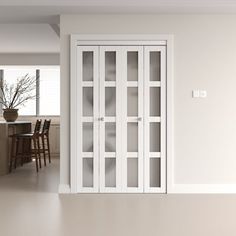 an empty room with white walls and glass doors