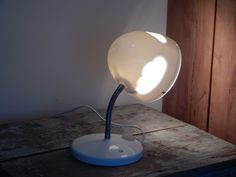 an apple shaped lamp on top of a wooden table