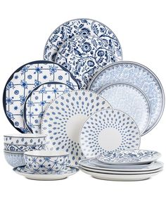 the blue and white dinnerware is stacked on top of each other, with an intricate design