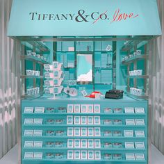 tiffany & co store display with blue shelves and white boxes on the shelf, in front of it