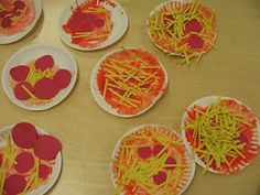 paper plates with hearts and sticks on them are sitting on a table, ready to be made into valentine's day crafts