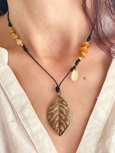 ️️🍁 ✨ Autumn leaf and yellow Aventurine necklace ✨ Natural stones and golden beads on black waxed cord, aged gold charm and clasp, glitter and gold leaf details🌙🕯️📿🪞 ✨ Yellow aventurine brings calm and balances emotions, it soothes and strengthens self-esteem by giving strength and courage. It also boosts creativity and positivity 💛 ✨ Adjustable cord length between 40 and 46cm ✨ Pendant 5 x 2.5cm #necklace #jewel #handmade #pearls #magic #craftswoman #gems #naturalstones #jewelry #crafts # Yellow Aventurine, Aventurine Necklace, Golden Beads, Boost Creativity, Artificial Stone, Autumn Leaf, Necklace Gemstone, Gold Charm, Pearl Beads