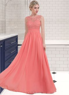 a woman standing in a bathroom wearing an orange dress