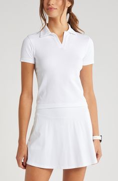 A seamless rib brings easy comfort and style to a preppy polo that will keep your focus on the court. 20" length (size Medium) Spread collar Short sleeves 91% nylon, 6% polyester 3% spandex Machine wash, tumble dry Imported Polo Collar Shirt Women Outfit, White Ribbed Polo Collar Top, White Ribbed Top With Polo Collar, Casual Stretch Activewear For Golf, White Tops With Ribbed Waistband For Spring, Fitted Sports Top With Polo Collar, Sports Polo Collar Fitted Top, Casual White Stretch Polo Shirt, Fitted Polo Shirt With Ribbed Collar For Golf