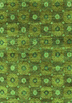 a green rug with an intricate design on the top and bottom corner, in different colors