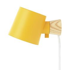 a yellow wall light with a wooden arm