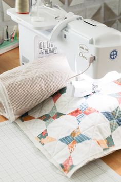 a sewing machine sitting on top of a quilt